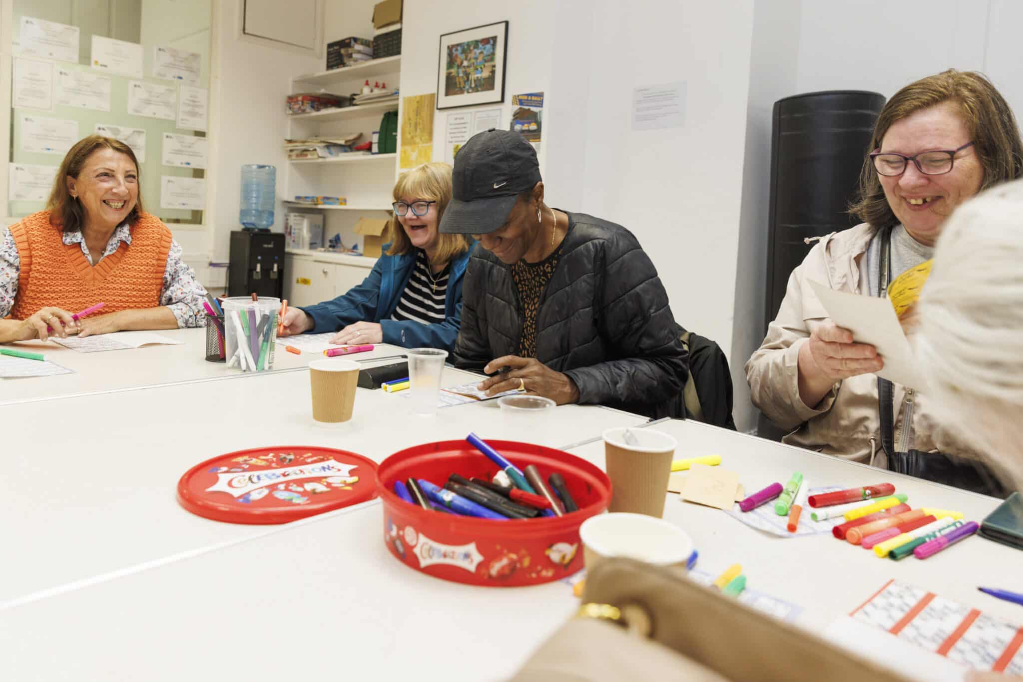 A group of adult women using coloured pens to play bingo at World's End Big Local
