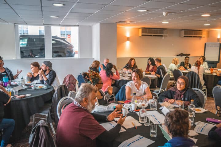 Adults sitting at a round table at an event